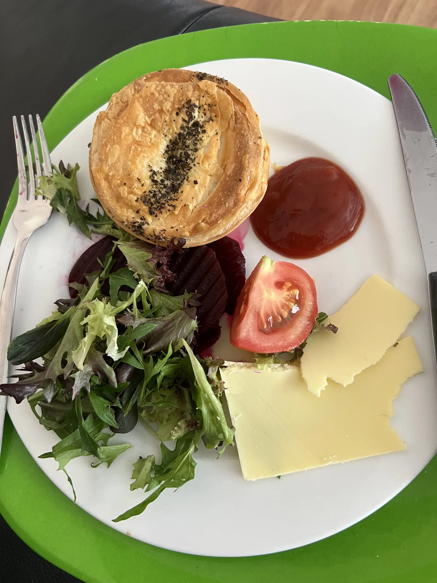 Plate with pie, salad, beetroot, tomato and sauce