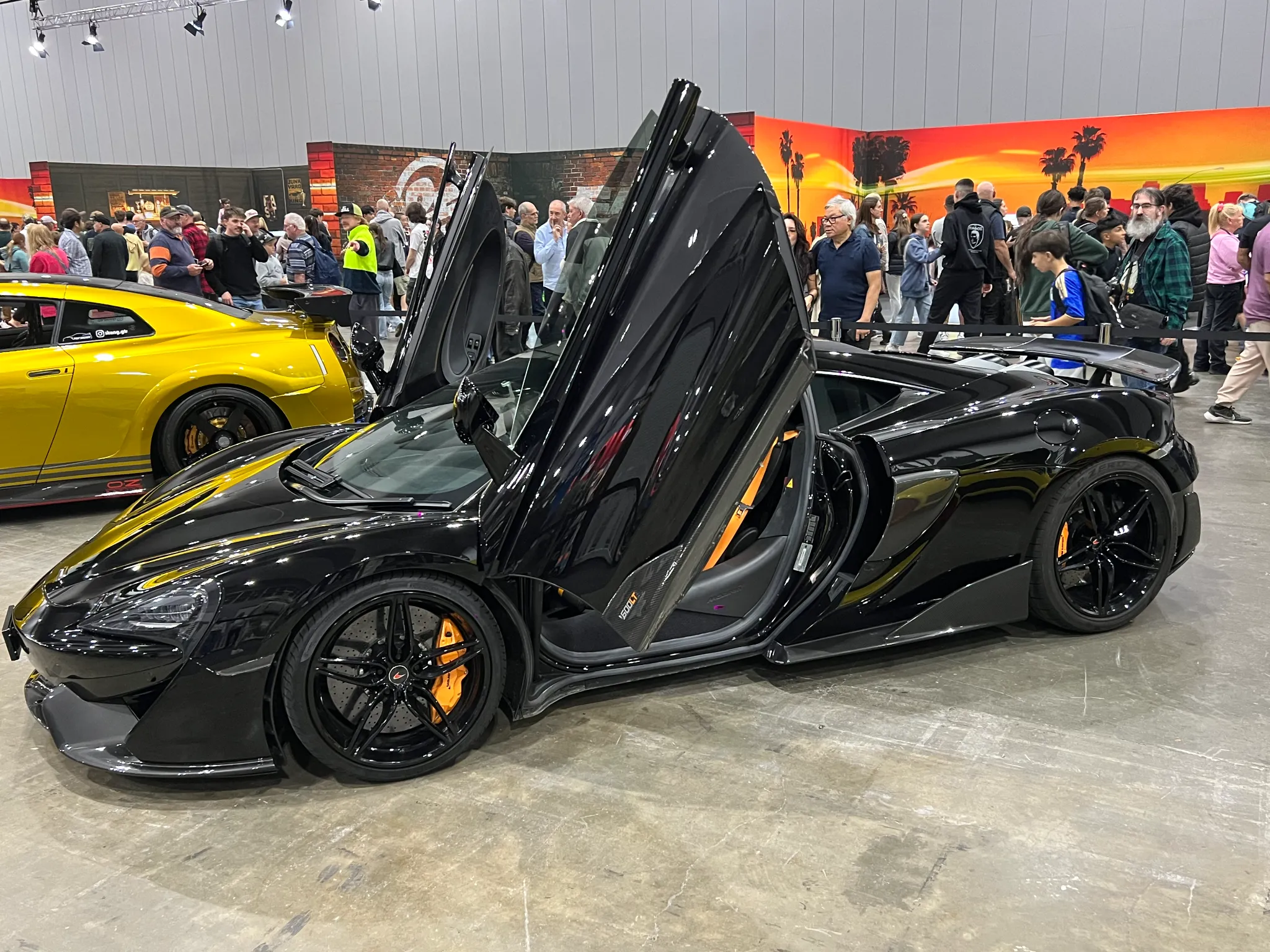 Black McLaren with doors up at Melbourne Motor Show 2026